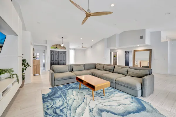 a living room with furniture a rug and a chandelier