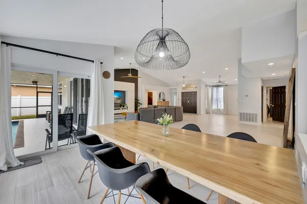 a room with lots of dining table and chairs