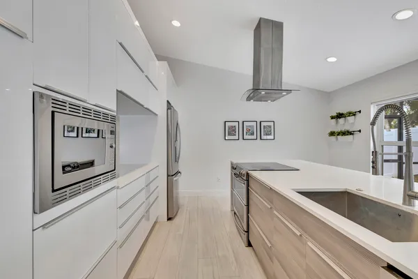 a kitchen with a sink and chandelier
