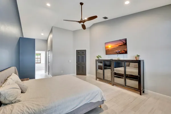 a bedroom with a bed and a flat screen tv