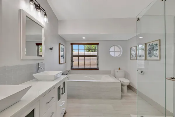 a bathroom with a double vanity sink and mirror