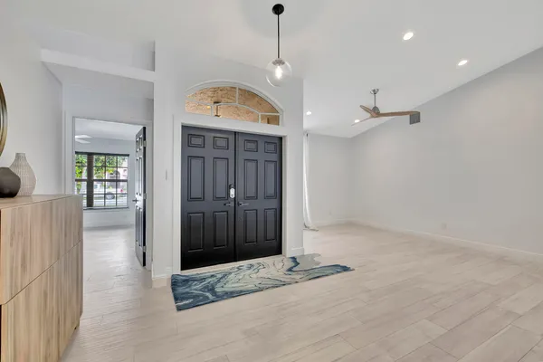 a view of a hallway with a chandelier