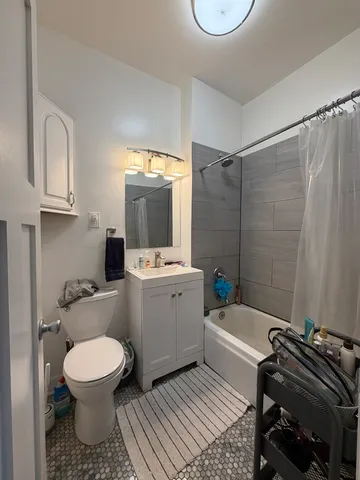 a bathroom with a toilet a sink and a mirror