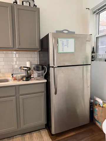 a white refrigerator freezer sitting in a kitchen