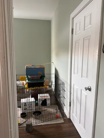 a living room with lots of furniture and baby crib