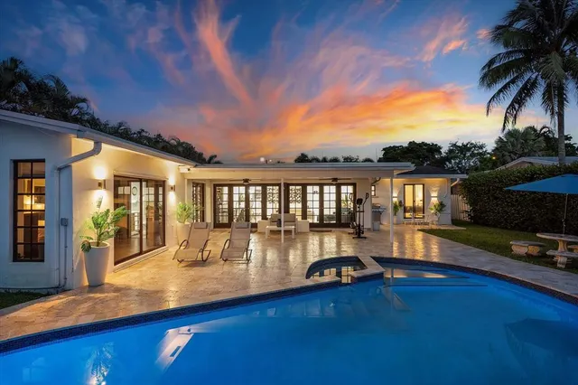 a view of a patio with swimming pool table and chairs
