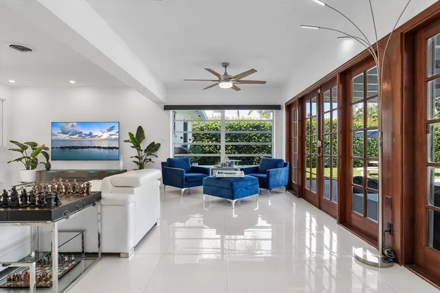 a living room with furniture and a large window with outer view