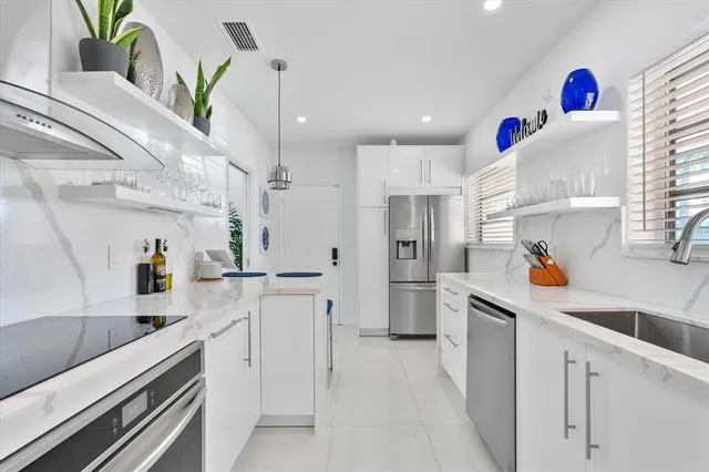 a kitchen that has a sink and a stove in it
