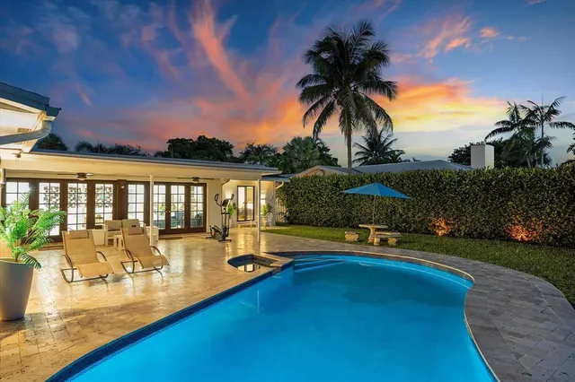 swimming pool view with a garden space