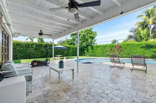 a view of a patio with table and chairs potted plants with wooden fence
