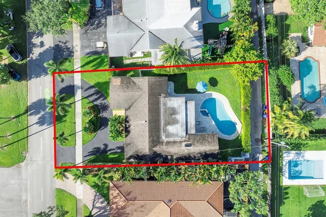 a green field with flowers and trees