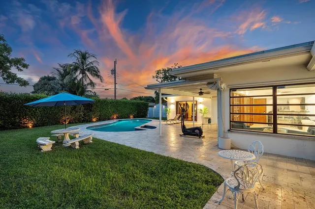 a view of a house with backyard porch and sitting area