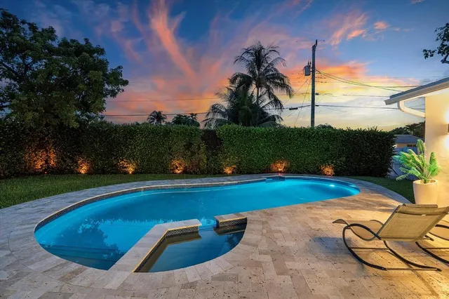 a view of a swimming pool with an outdoor space and seating area