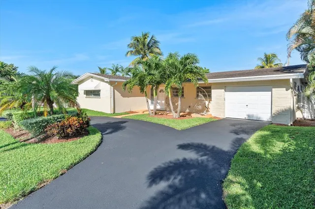 a front view of a house with a yard and a garage