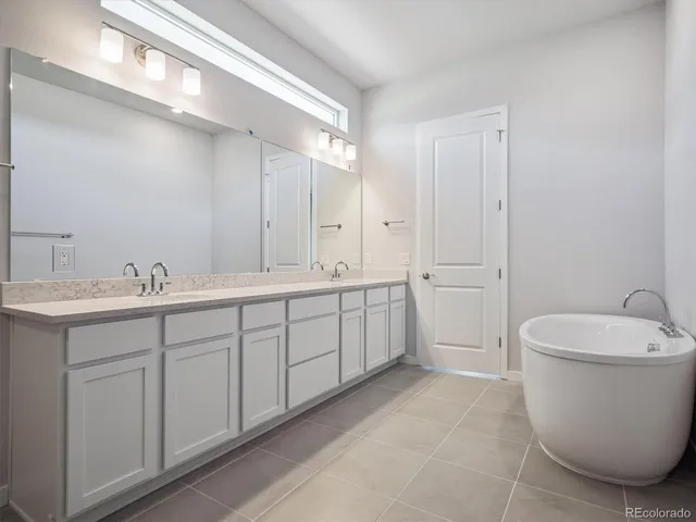 a spacious bathroom with a double vanity sink mirror and toilet