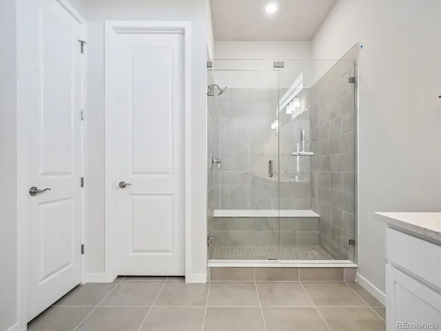 a bathroom with a shower and a glass door