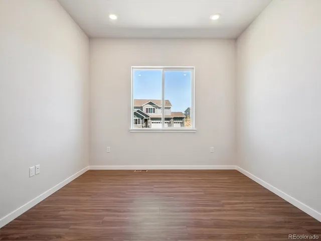 a view of wooden floor and windows in a room