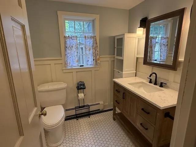 a bathroom with a granite countertop sink toilet and shower