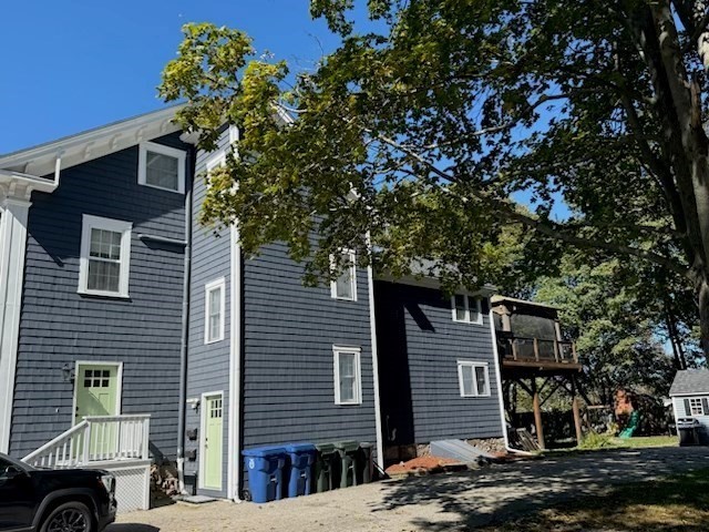 10 River Street, Unit 1 Danvers, MA 01923 - Photo 2 of 17 a front view of a house with a garden