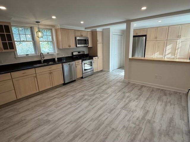 10 River Street, Unit 1 Danvers, MA 01923 - Photo 5 of 17 a large kitchen with granite countertop wooden floors a stove a sink and a window