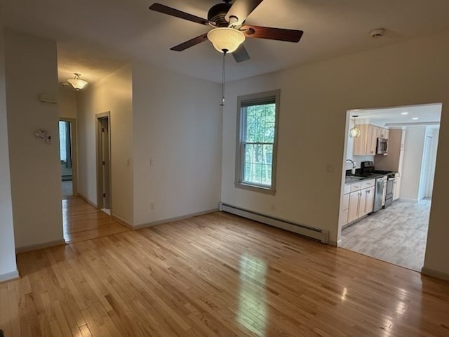 10 River Street, Unit 1 Danvers, MA 01923 - Photo 7 of 17 a view of an empty room with window and wooden floor