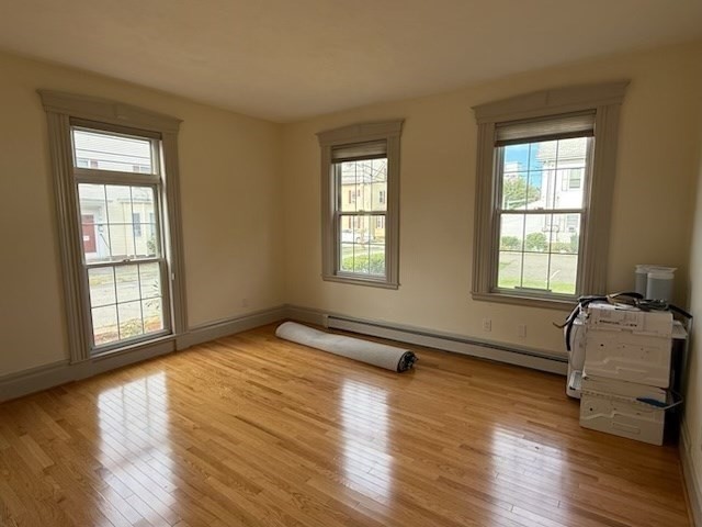 10 River Street, Unit 1 Danvers, MA 01923 - Photo 10 of 17 a spacious bedroom with two beds and wooden floor