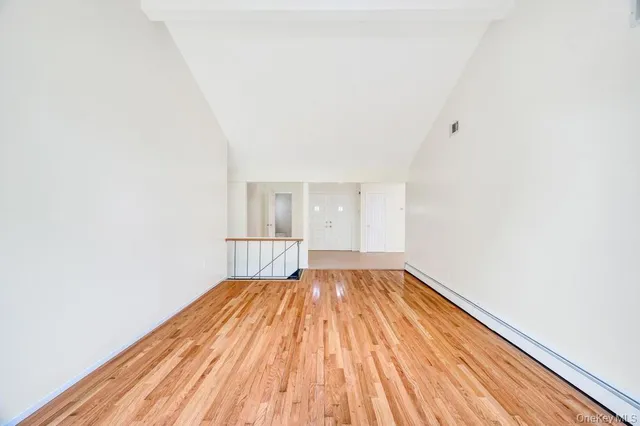 a view of a room with wooden floor and fence
