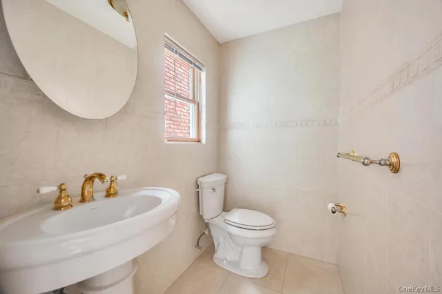 a white toilet sitting next to a bathroom sink