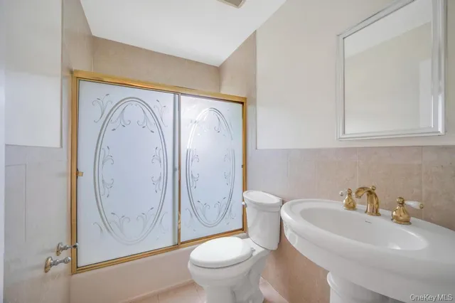 a bathroom with a toilet and a sink