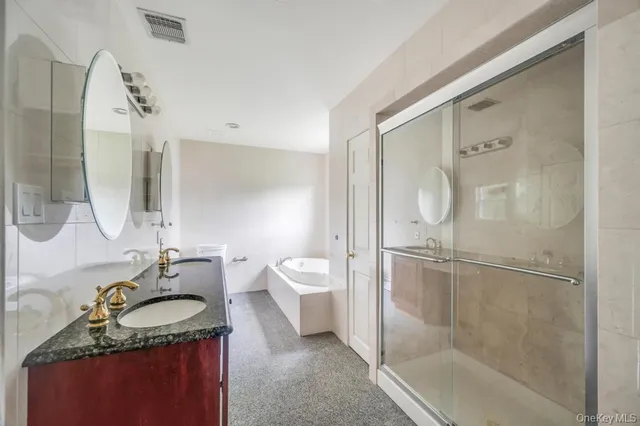 a bathroom with a granite countertop sink a toilet and shower