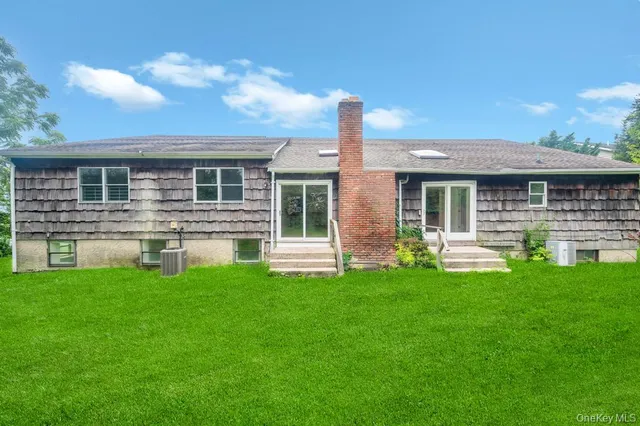a front view of house with yard and outdoor seating