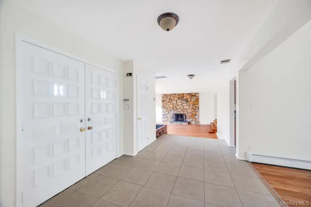 a large white room with a large window and couch