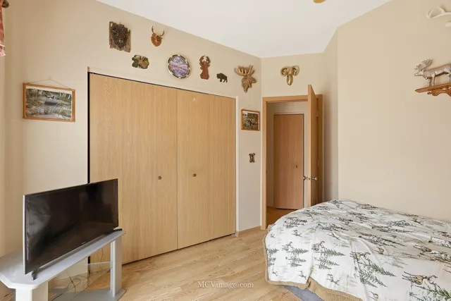 a bedroom with a bed and a flat screen tv