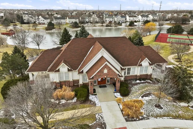 an aerial view of a house with a lake view