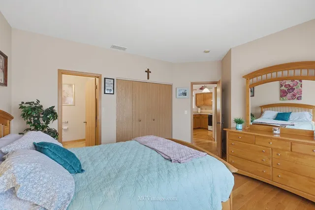 a bedroom with a bed and a dresser