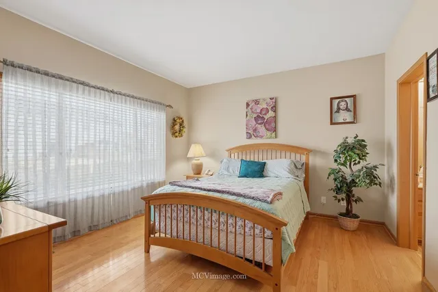 a bedroom with a bed and a potted plant