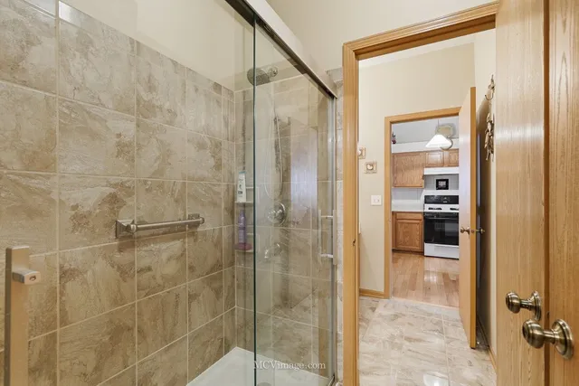 a bathroom with a shower and a sink