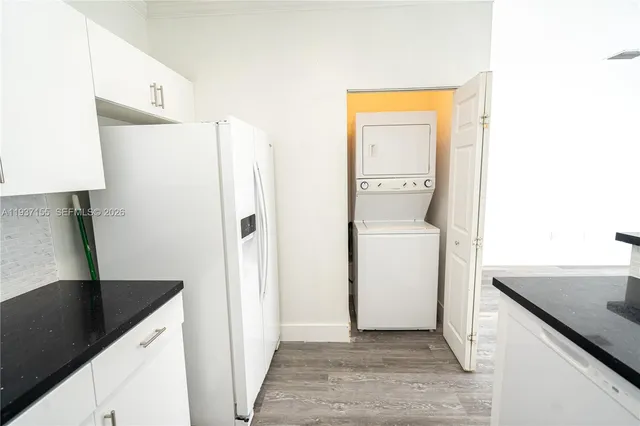 a kitchen with a refrigerator and a sink
