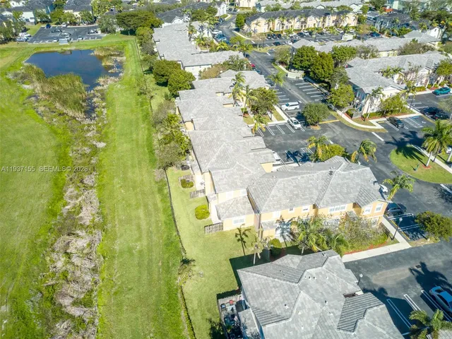 an aerial view of residential houses with outdoor space