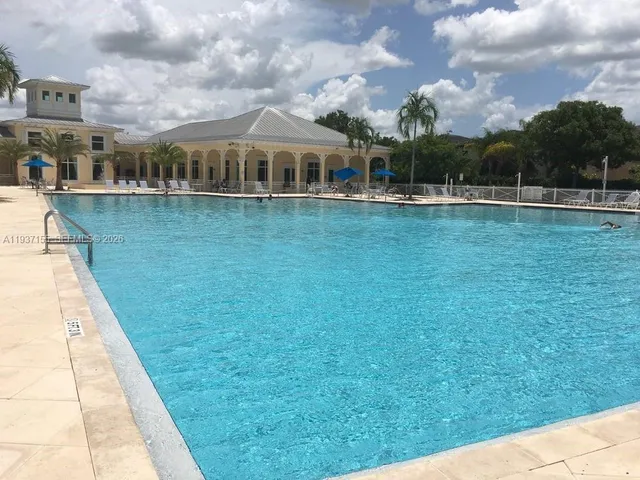 a view of residential houses with yard and lake view