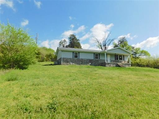 27 Sloan Branch Road Pleasant Shade, TN 37145 - Photo 1 of 35 a front view of a house with a yard and garage