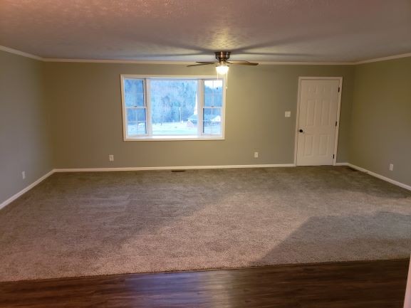 27 Sloan Branch Road Pleasant Shade, TN 37145 - Photo 4 of 35 a view of an empty room with a window and wooden floor
