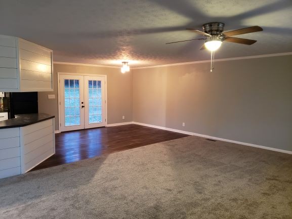27 Sloan Branch Road Pleasant Shade, TN 37145 - Photo 7 of 35 en empty room with wooden floor a ceiling fan and a window