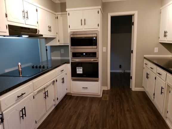 27 Sloan Branch Road Pleasant Shade, TN 37145 - Photo 8 of 35 a kitchen with granite countertop white cabinets and stainless steel appliances