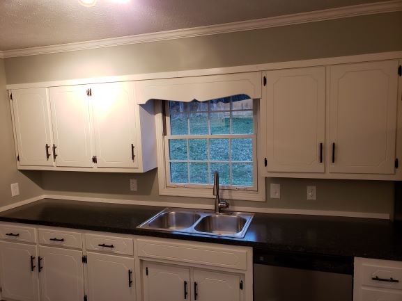 27 Sloan Branch Road Pleasant Shade, TN 37145 - Photo 10 of 35 a kitchen with granite countertop white cabinets and a sink