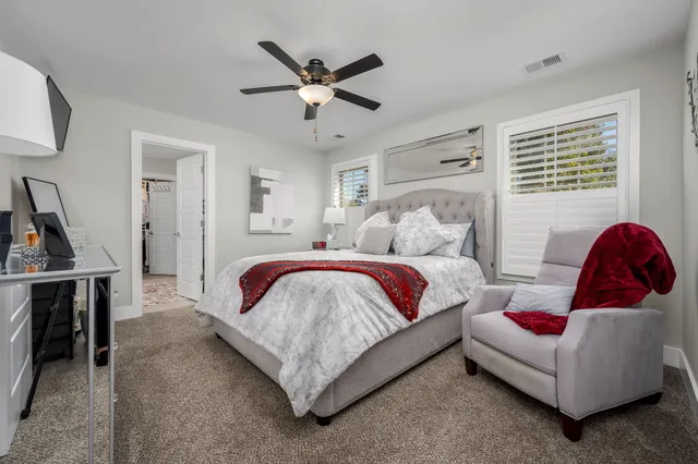 a spacious bedroom with a bed and a couch