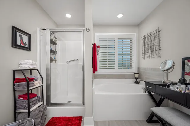 a bathroom with a tub and a shower