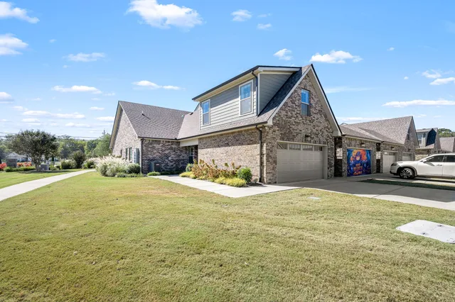 a view of a house with a yard and garage