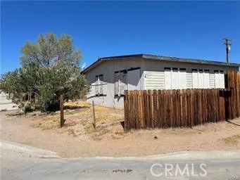 a view of a house with a wooden fence