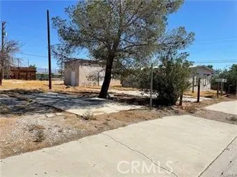 a backyard of a house with barbeque oven and seating space